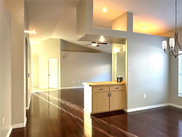 interior space featuring vaulted ceiling, dark hardwood / wood-style floors, and a chandelier