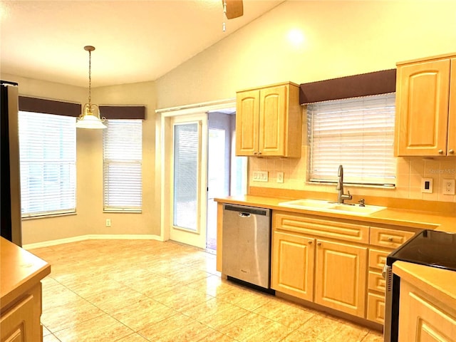 kitchen featuring appliances with stainless steel finishes, pendant lighting, lofted ceiling, sink, and decorative backsplash