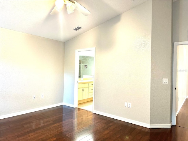 unfurnished bedroom with ceiling fan, wood-type flooring, connected bathroom, and vaulted ceiling