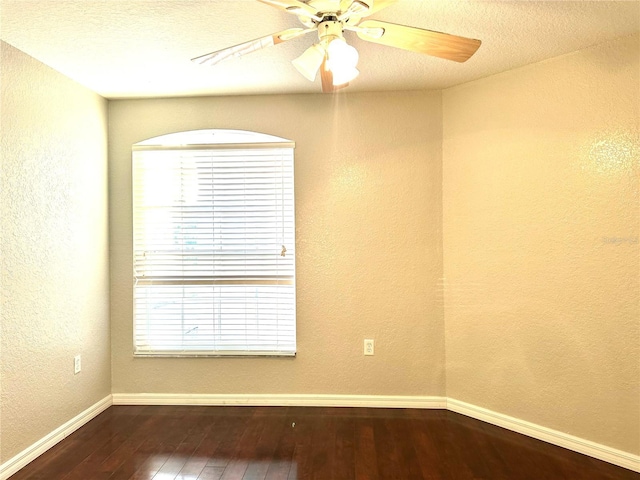 spare room featuring a textured ceiling, dark hardwood / wood-style floors, and ceiling fan