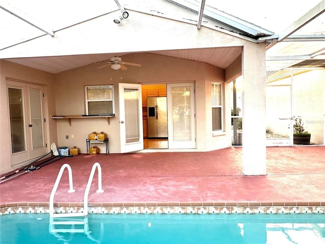 view of pool featuring a lanai, a patio, and ceiling fan