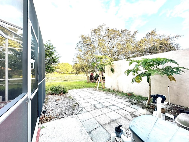 view of patio / terrace featuring a lanai