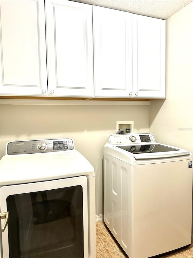 laundry room with cabinets and separate washer and dryer