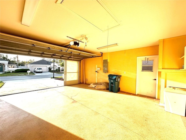 garage featuring a garage door opener and electric panel