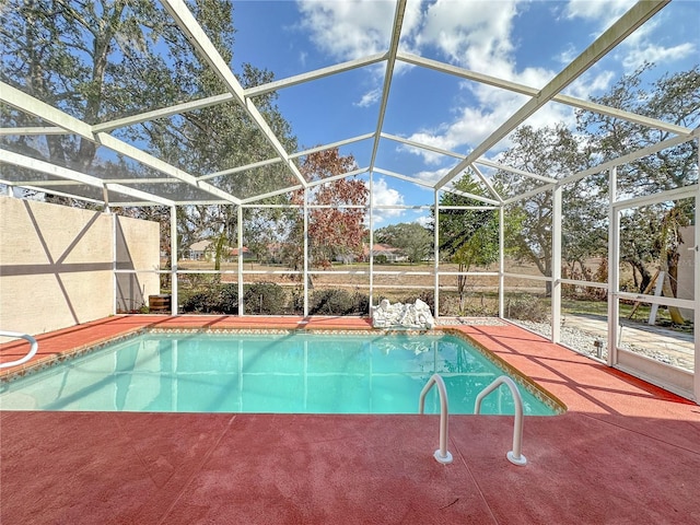 view of pool featuring a patio and glass enclosure