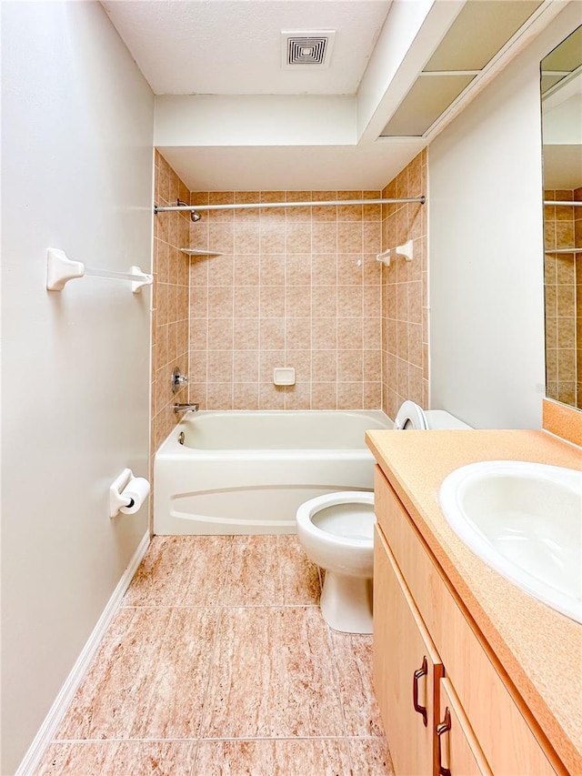 full bathroom featuring vanity, tiled shower / bath combo, and toilet