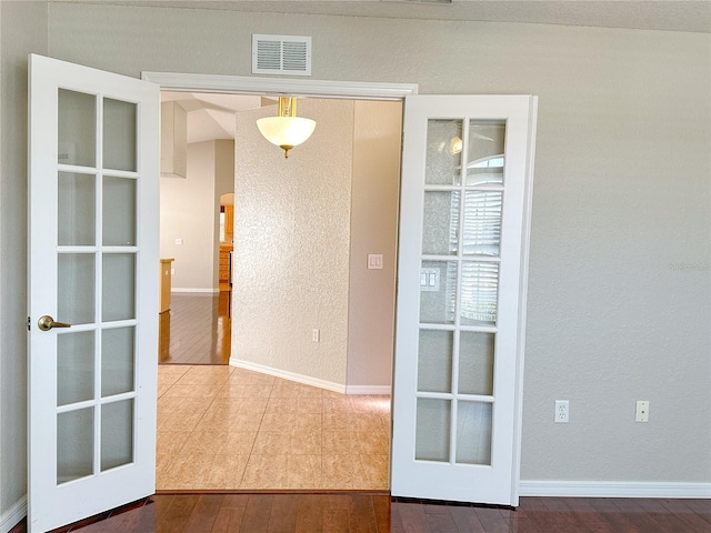 interior space featuring hardwood / wood-style flooring and french doors