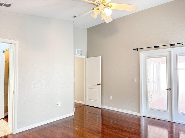 empty room with ceiling fan and dark hardwood / wood-style flooring