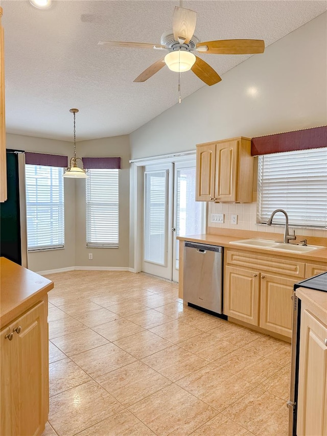 kitchen with sink, refrigerator, hanging light fixtures, stainless steel dishwasher, and light brown cabinets