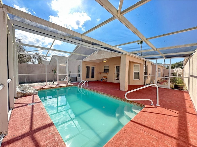 view of pool featuring french doors, a patio, and glass enclosure