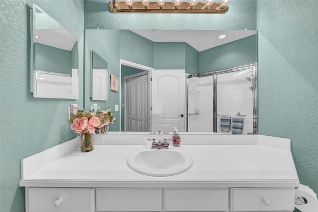 bathroom with vanity and an enclosed shower