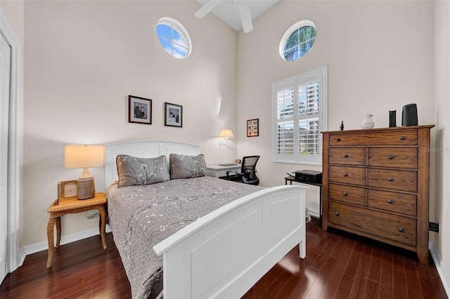 bedroom featuring high vaulted ceiling and dark hardwood / wood-style floors