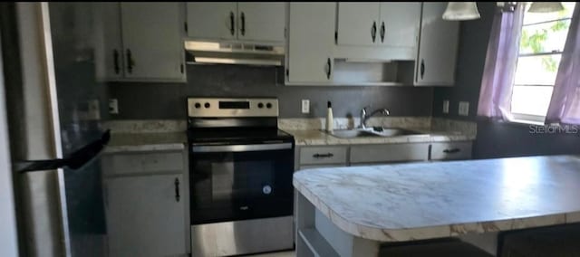 kitchen featuring appliances with stainless steel finishes, sink, and white cabinets