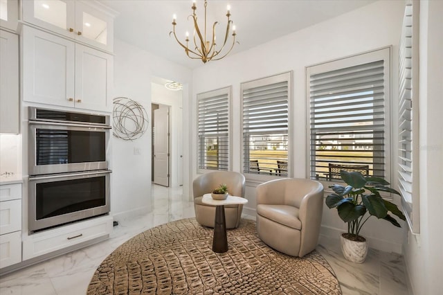 sitting room featuring an inviting chandelier