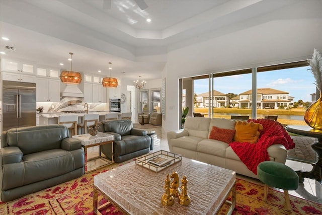 living room with an inviting chandelier and a towering ceiling