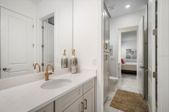 bathroom featuring vanity and toilet