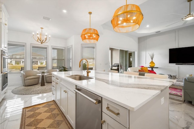 kitchen featuring sink, light stone counters, stainless steel dishwasher, pendant lighting, and white cabinets