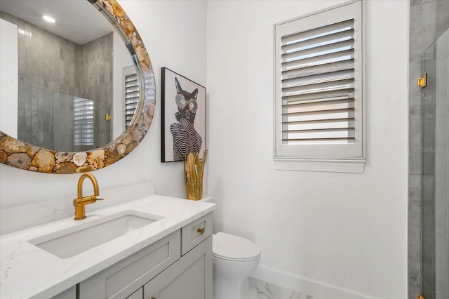 bathroom with vanity, toilet, and a shower with shower door