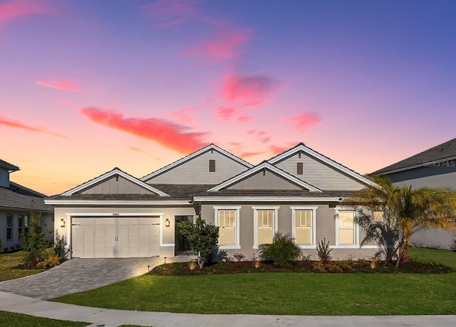 33843 Galley Way, Wesley Chapel, FL 33543 - view of front facade featuring a yard, a garage, stucco siding, and driveway