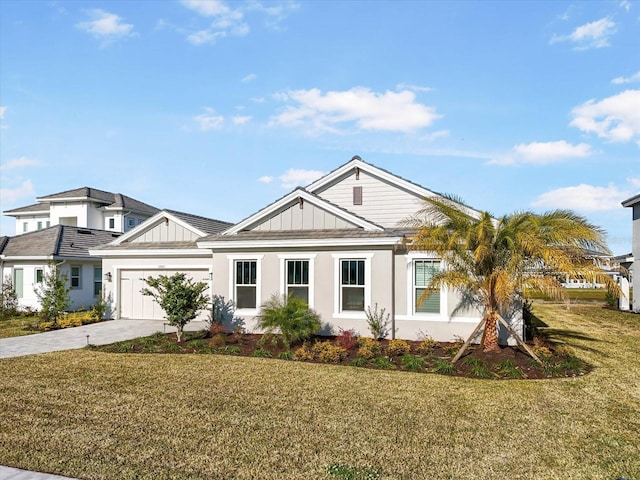 33843 Galley Way, Wesley Chapel, FL 33543 - view of front facade with driveway, a front yard, board and batten siding, and a garage