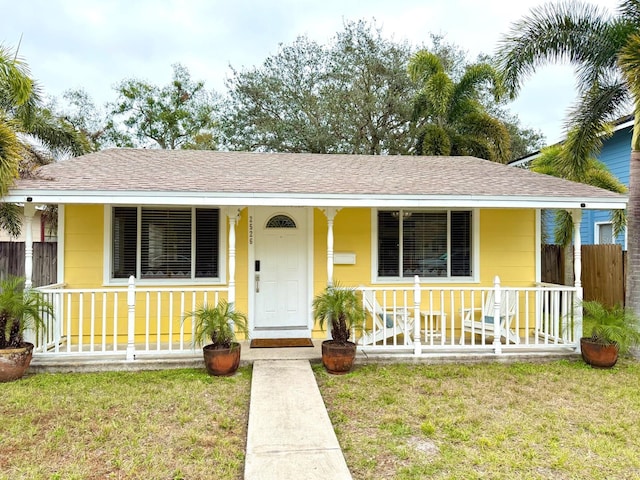 view of front of house with a front yard and covered porch