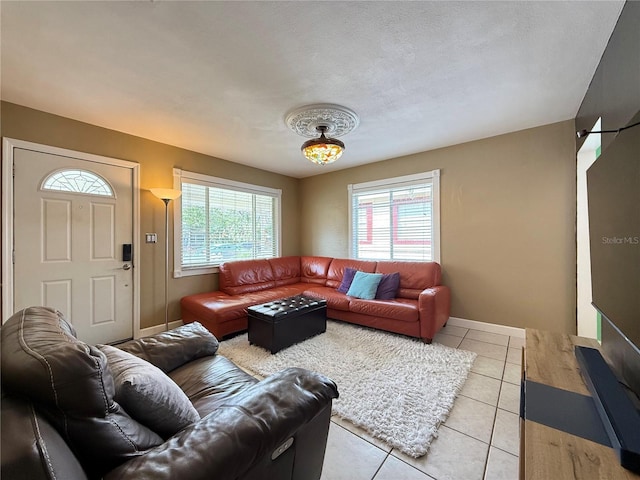 living room featuring light tile patterned floors and a textured ceiling