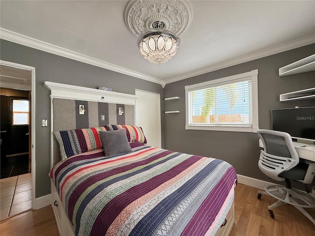 bedroom with hardwood / wood-style flooring and crown molding