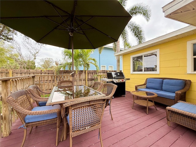 deck with a grill and an outdoor living space