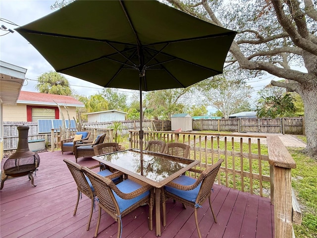 wooden terrace featuring a storage unit