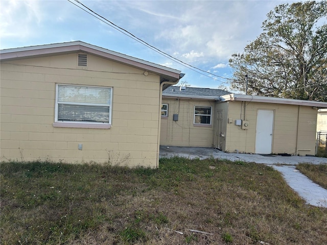 view of property exterior with a lawn