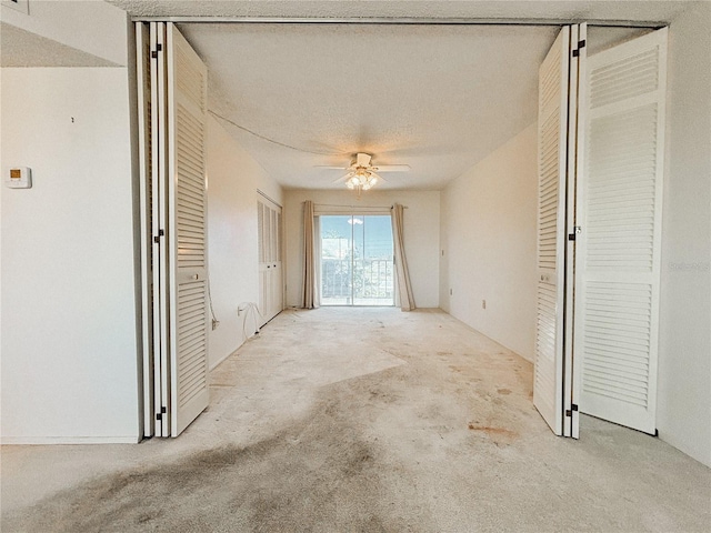 interior space with light colored carpet and a textured ceiling