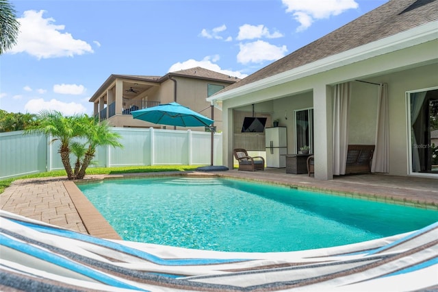 view of pool featuring ceiling fan and a patio