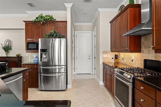 kitchen featuring backsplash, light tile patterned floors, stainless steel appliances, crown molding, and wall chimney range hood