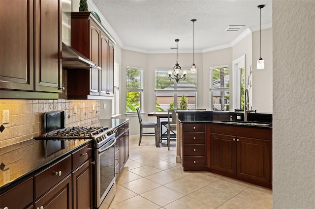 kitchen with decorative light fixtures, sink, crown molding, gas stove, and an inviting chandelier