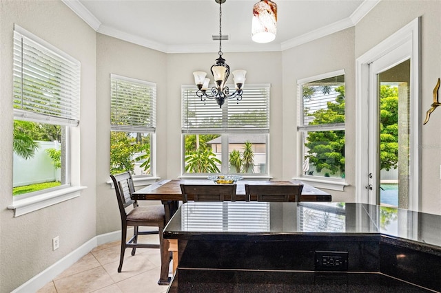 tiled dining area featuring ornamental molding, a healthy amount of sunlight, and a notable chandelier