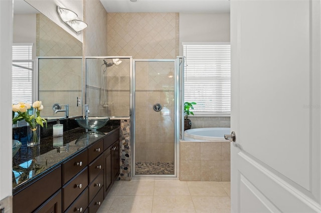 bathroom with tile patterned floors, shower with separate bathtub, and vanity