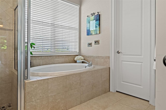 bathroom with tile patterned flooring and independent shower and bath