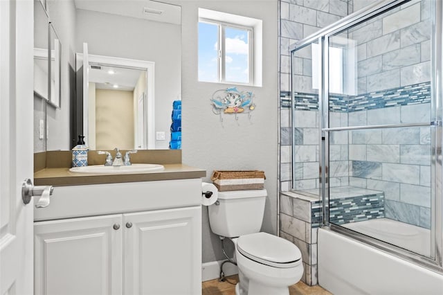 full bathroom featuring vanity, toilet, and combined bath / shower with glass door