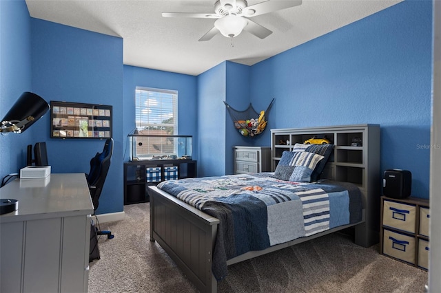 bedroom with ceiling fan, carpet floors, and a textured ceiling