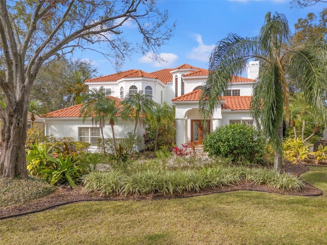 mediterranean / spanish home featuring a front yard