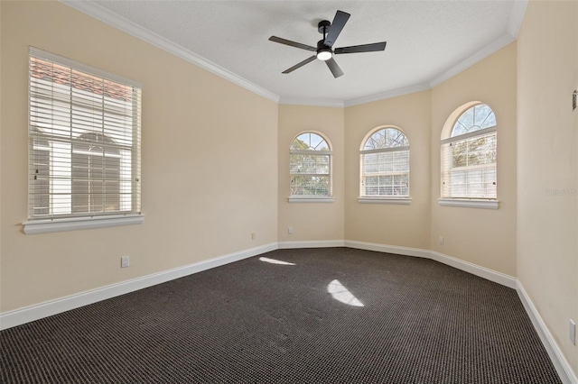 carpeted spare room featuring crown molding, ceiling fan, and a textured ceiling