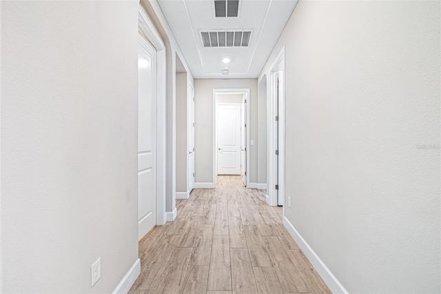 corridor with light hardwood / wood-style floors