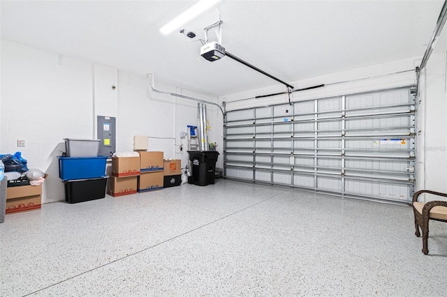 garage with a garage door opener and electric panel