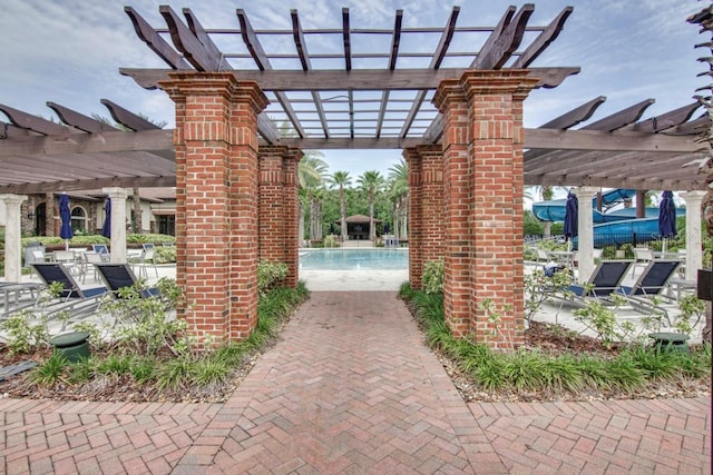 view of patio / terrace with a community pool and a pergola