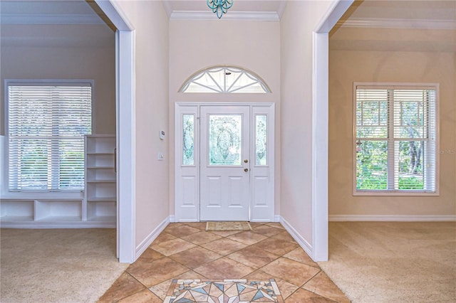 carpeted entryway with crown molding