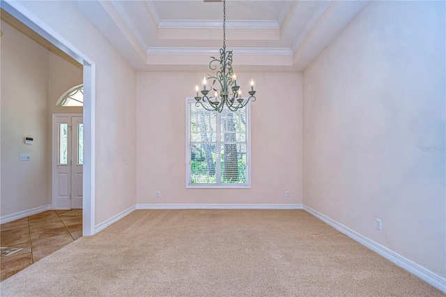 unfurnished room featuring crown molding, a raised ceiling, a chandelier, and carpet flooring