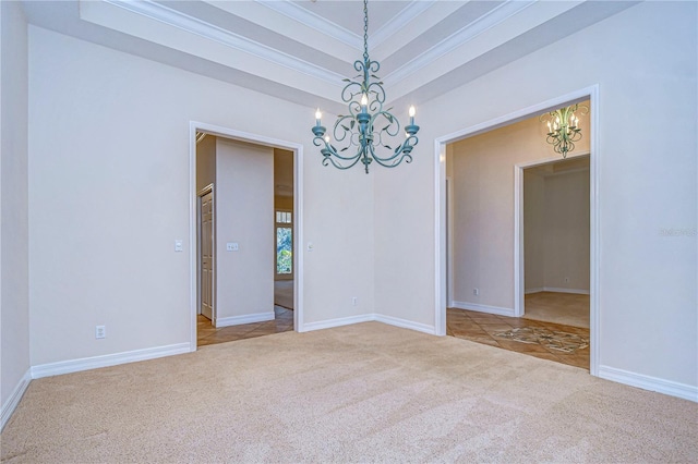 spare room with crown molding, light colored carpet, a raised ceiling, and a notable chandelier