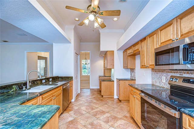 kitchen featuring sink, crown molding, dark stone countertops, stainless steel appliances, and tasteful backsplash