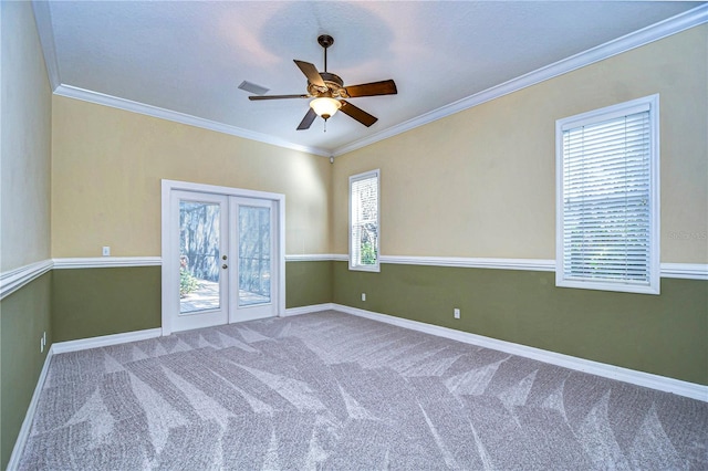 spare room with carpet floors, ornamental molding, french doors, and ceiling fan