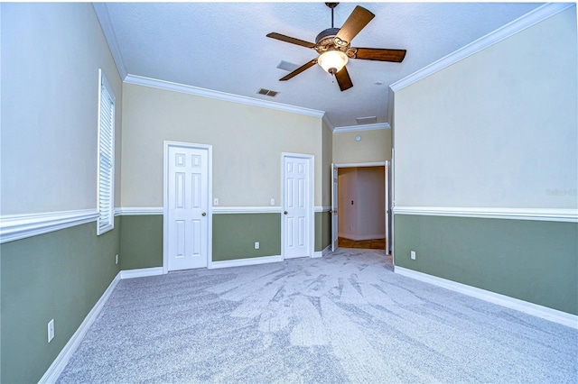 unfurnished bedroom featuring light carpet, ceiling fan, ornamental molding, and a textured ceiling